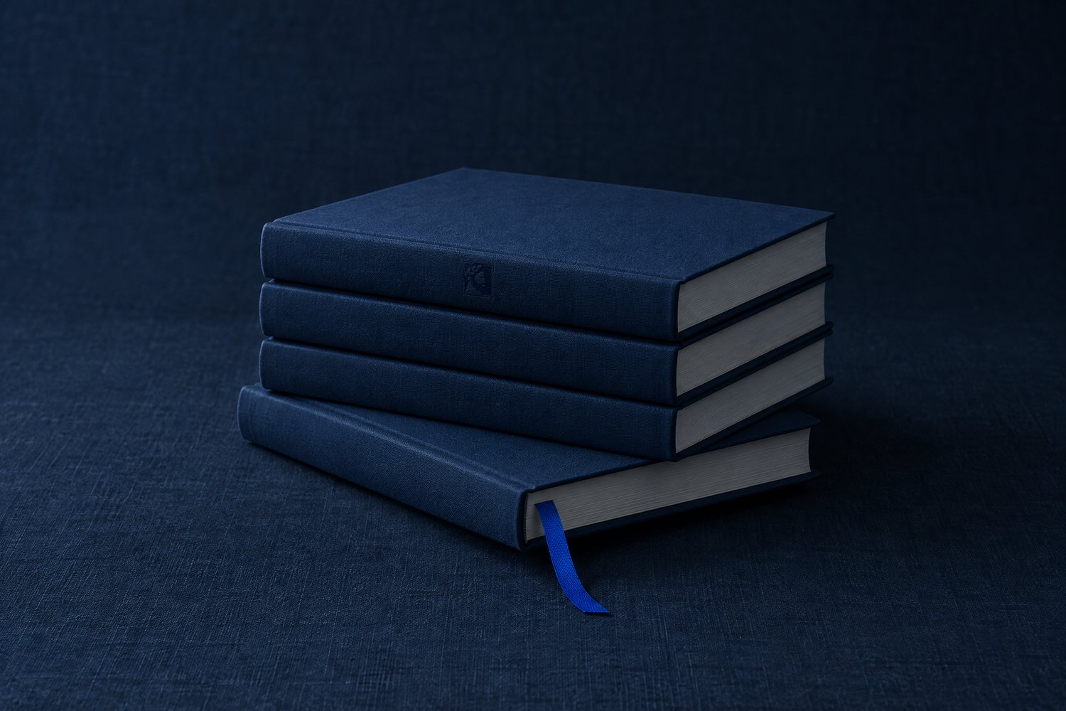 A stack of four navy hardcover books, the bottom one pushed out of line with a cobalt ribbon, the Olivent mark pressed into the top spine