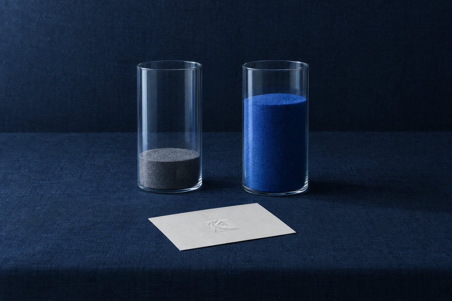 Two glass cylinders filled with sand to very different levels, and a white card embossed with the Olivent mark